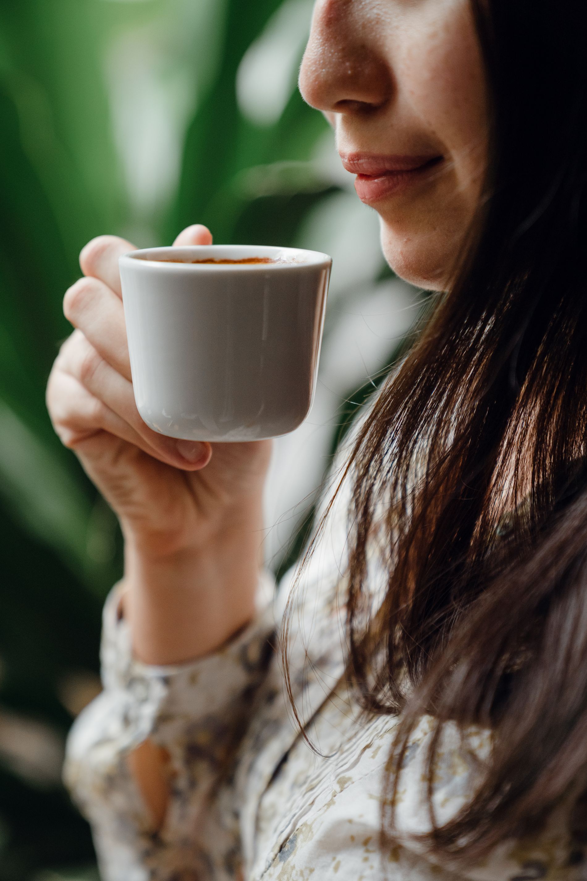 A customer pauses over an unbranded cup of coffee.