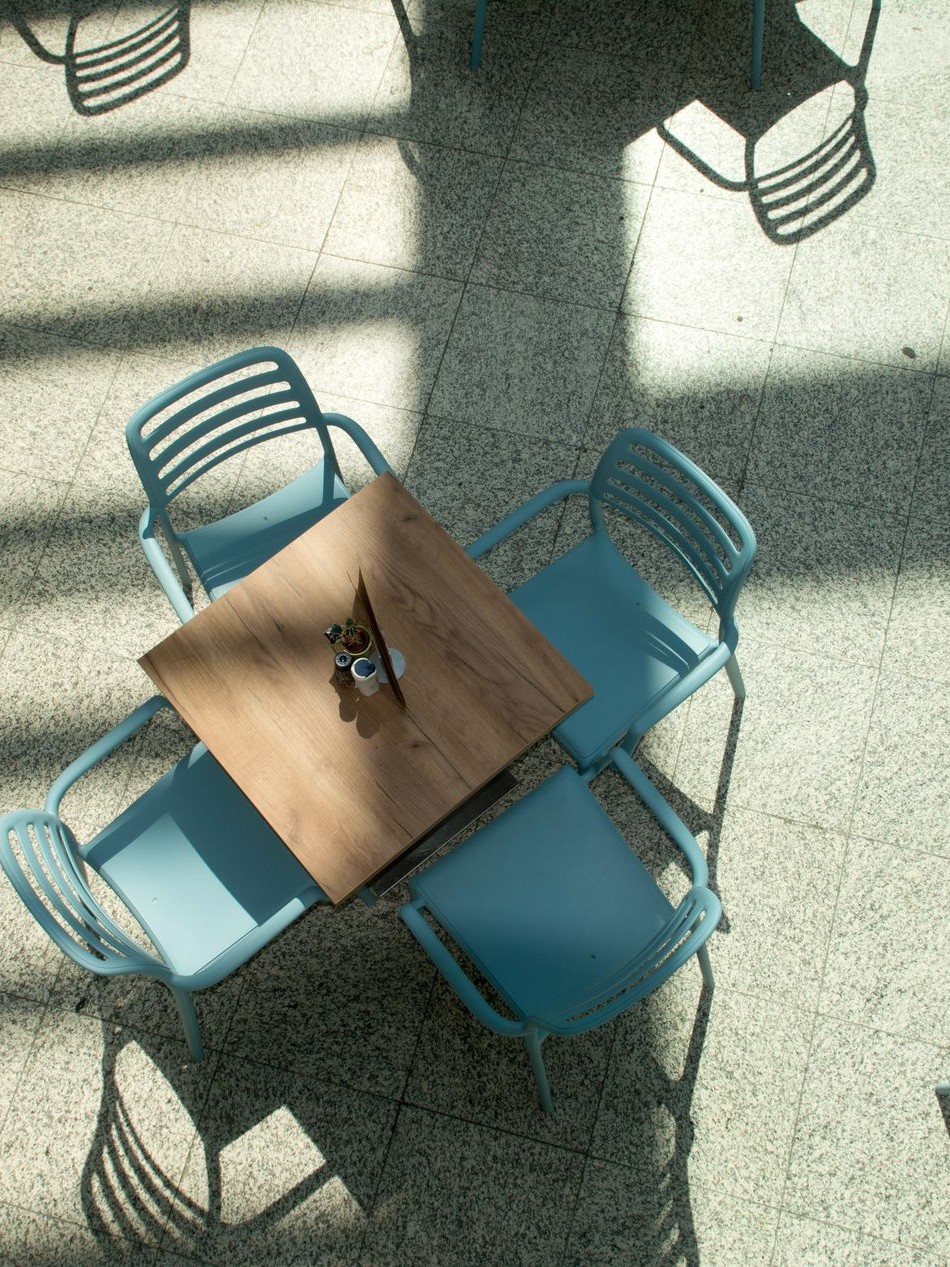 An empty café table and chairs in late afternoon light.