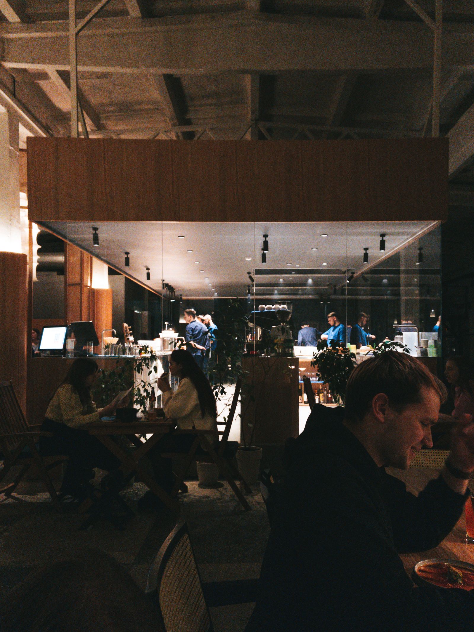 A restaurant dining room mid-service, several things happening at once.